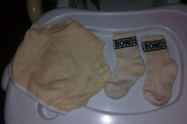 A pair of white on socks and panties, which have become discolored brown.