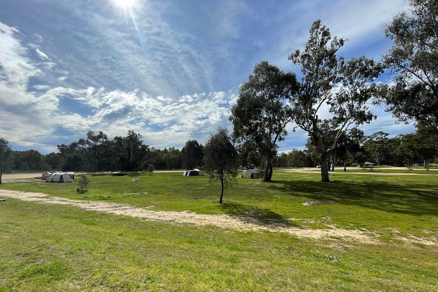 A large campground with a few tents.