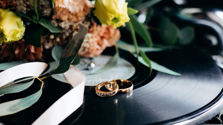 Old record player, with two rings placed on the turntable.