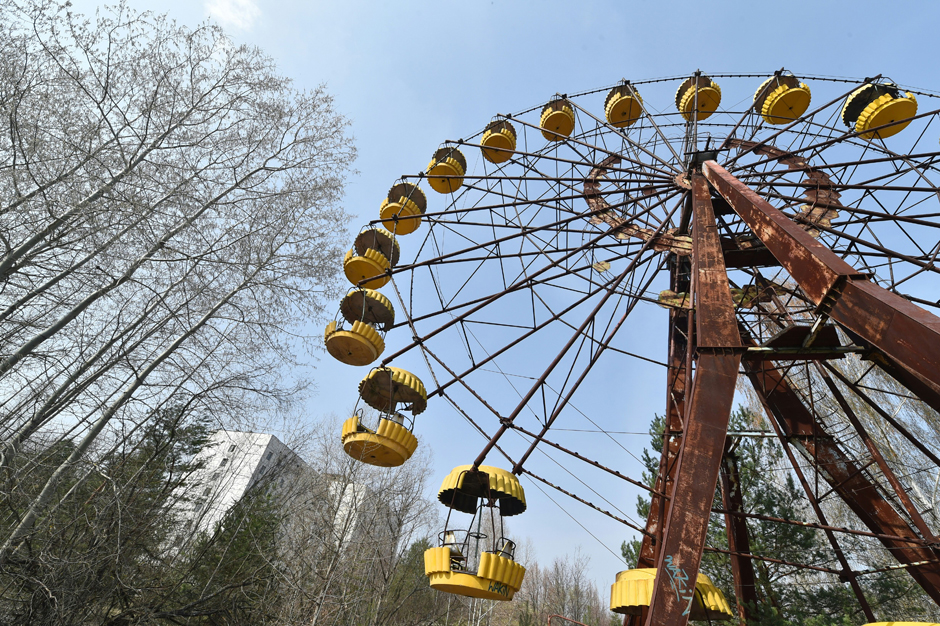 An abandoned Ferris wheel sits in the middle of the ghost city.