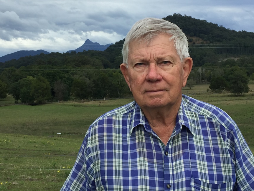 Colin Brook wearing a check shirt on his property.