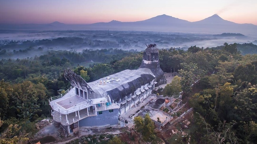 A building with a shape of a poultry on a hill.