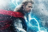 an australian actor dressed as norse god thor stands in a lighting storm
