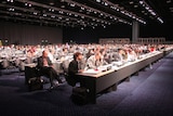 Delegates sit in the main plenary hall at the Bella Centre during the UN Climate Change Conference