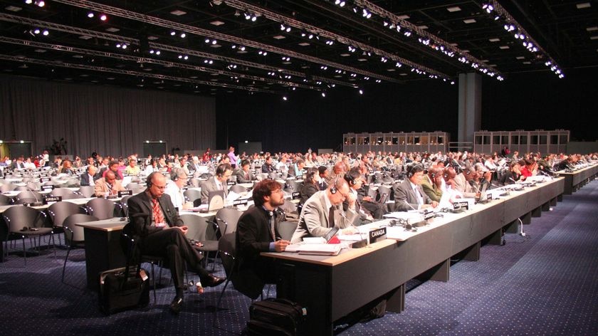 Delegates sit in the main plenary hall at the Bella Centre during the UN Climate Change Conference