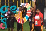 Athletes from the PNG team pose for a photo