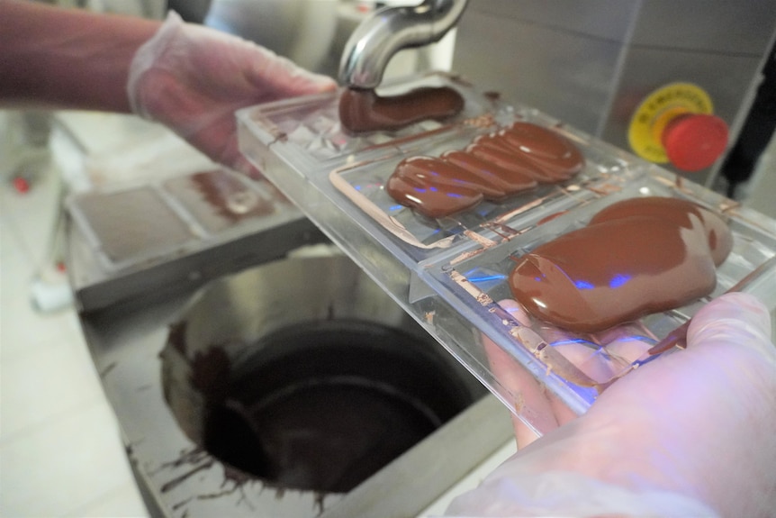 Chocolate being poured out of a tap. 