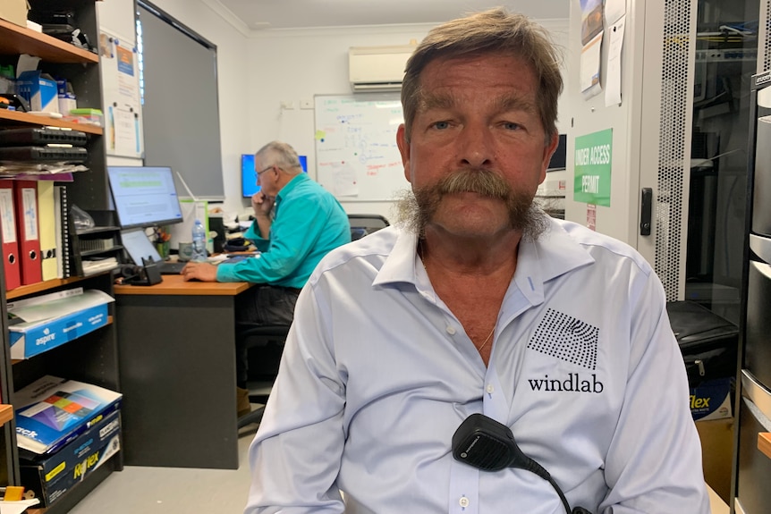 man in office of renewable energy farm