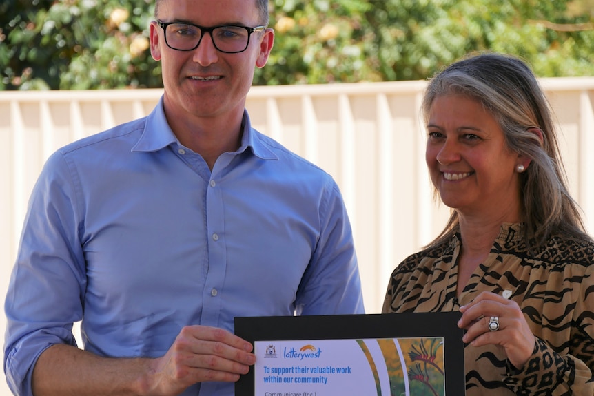Minister Carey presents the Communicare CEO with a $1.8 million-dollar grant for the Hedland Breathing Space program trial. 
