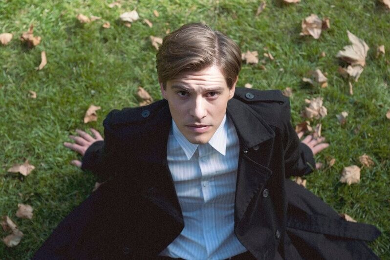 Image of actor Xavier Samuel sitting on grass looking up at the camera from the film The Death and Life of Otto Bloom