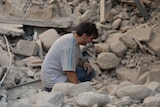 A man reacts to his damaged home after a strong earthquake hit Amatrice, Italy.