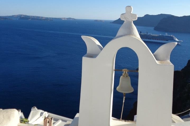 White washed church looks out upon the ocean.