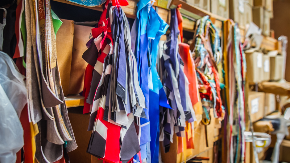 Dozens of different material samples are hung in the workshop to match handles and frames to.