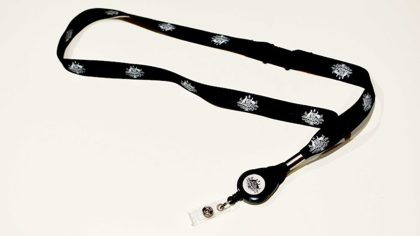 A lanyard with the Australian Government coat of arms on it sits on a white table.