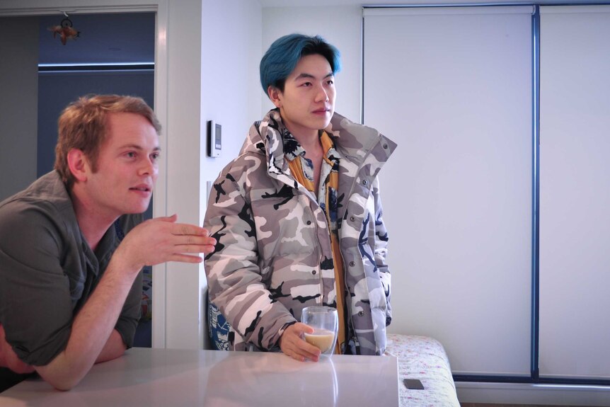 Chinese international student Xu Xiong stands in the kitchen of his Melbourne home.