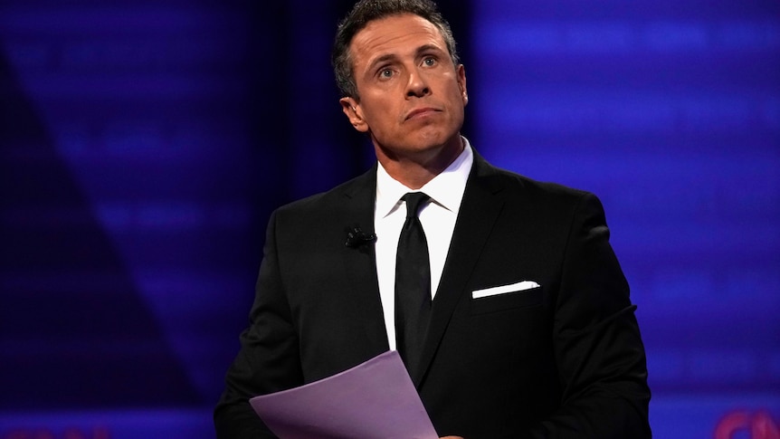 Chris Cuomo at a televised debate with politicians