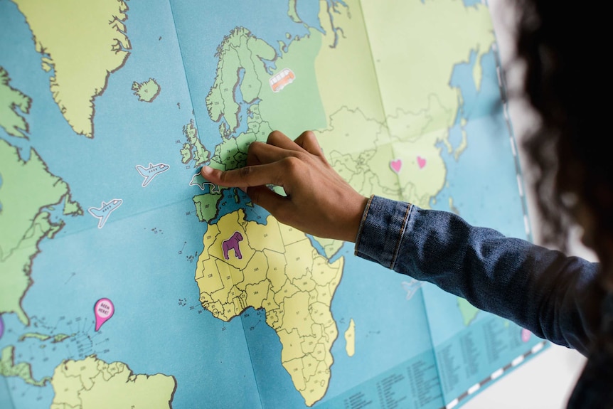 Woman putting a pin on a map