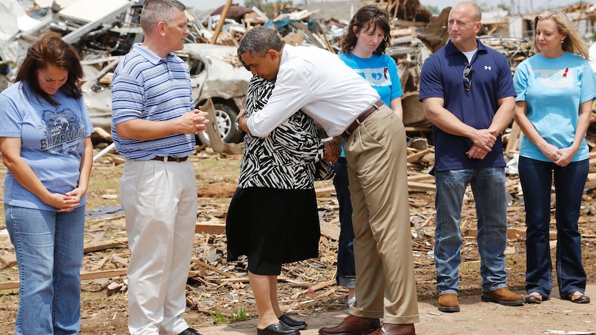 Barack Obama hugs woman in tornado-hit town.