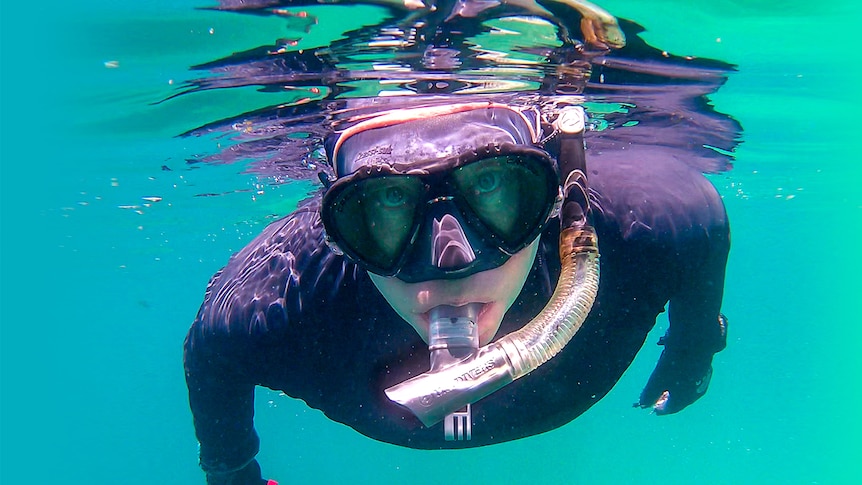 Ian Donato wearing a black wetsuit and snorkelling mask.