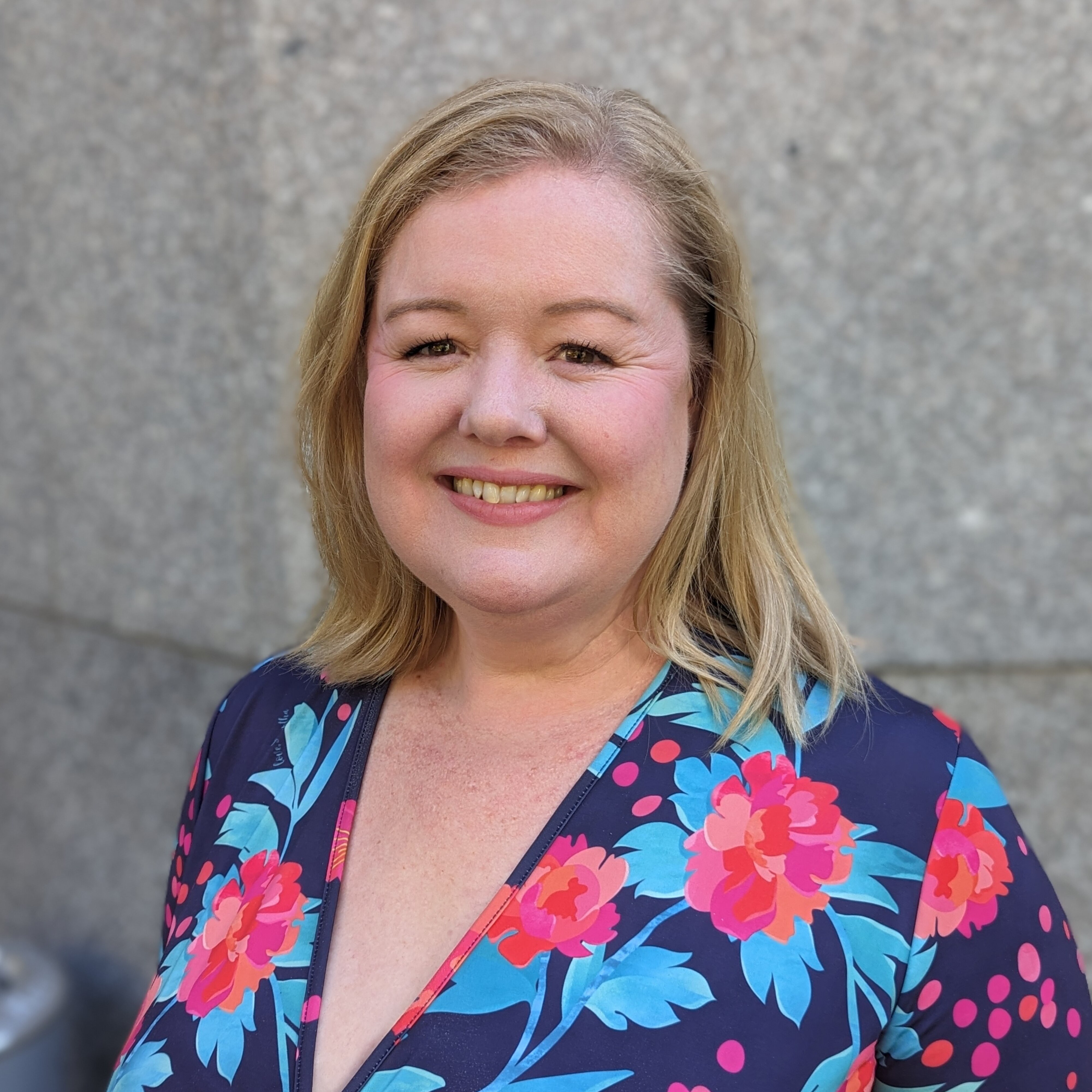a woman looks down the barrel of a camera