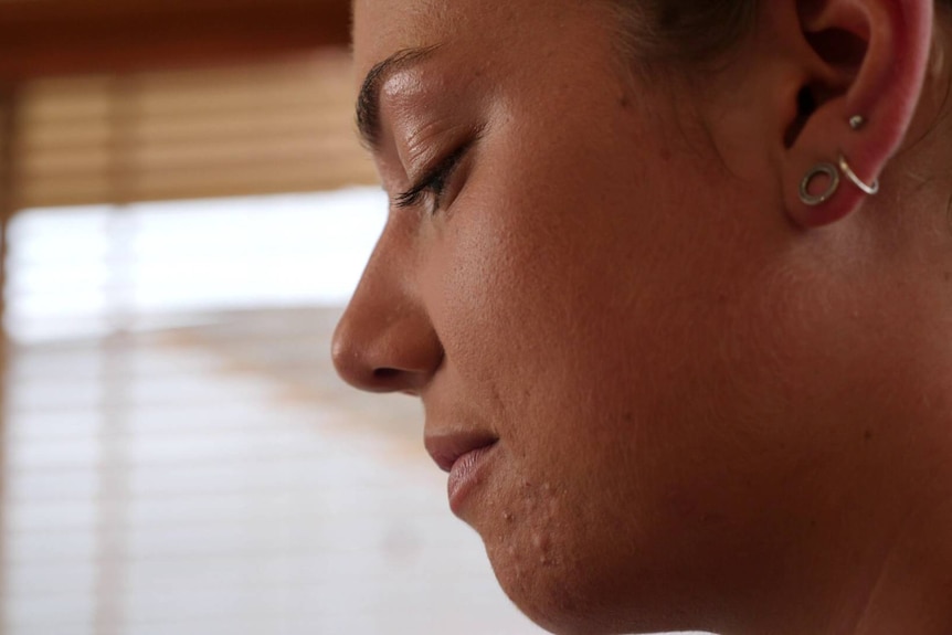 close up of a young woman looking down at her desk