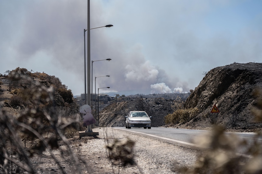 Smoke billowing over a road in Greece