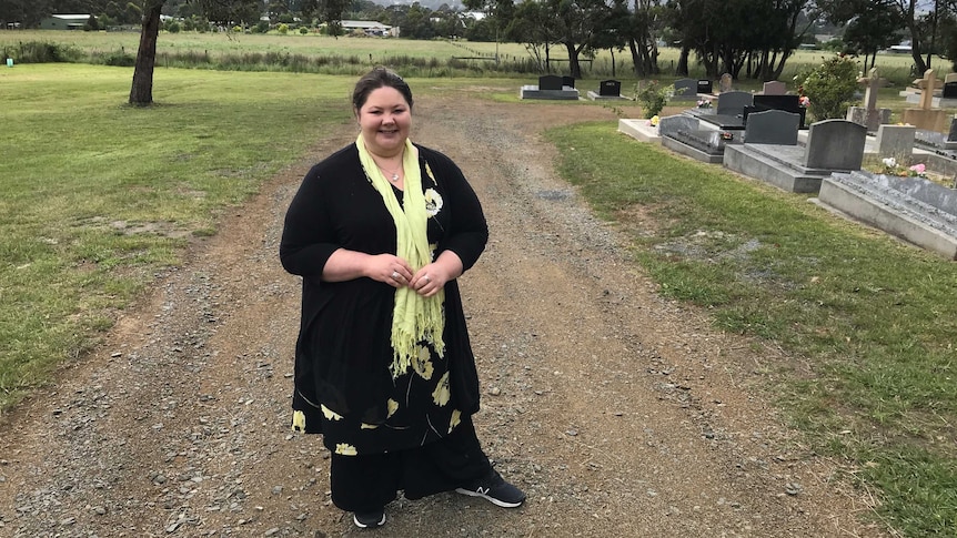 Bec Lyons standing in North West Bay Cemetery near Sandfly