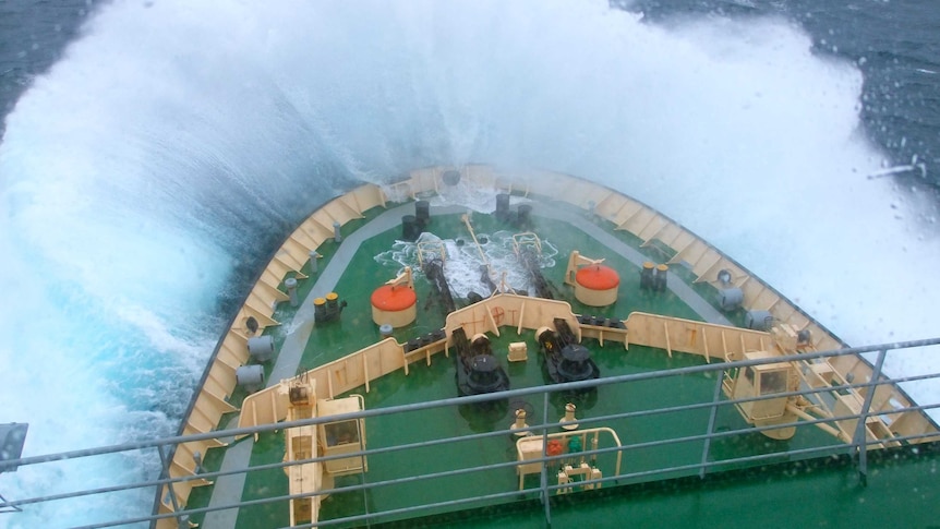 Waves crash over the front of a ship in the south Indian Ocean