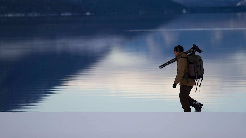 An image of Peter Lik walking with his camera gear, September 18 2014.