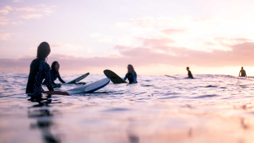 female surfers in the ocean