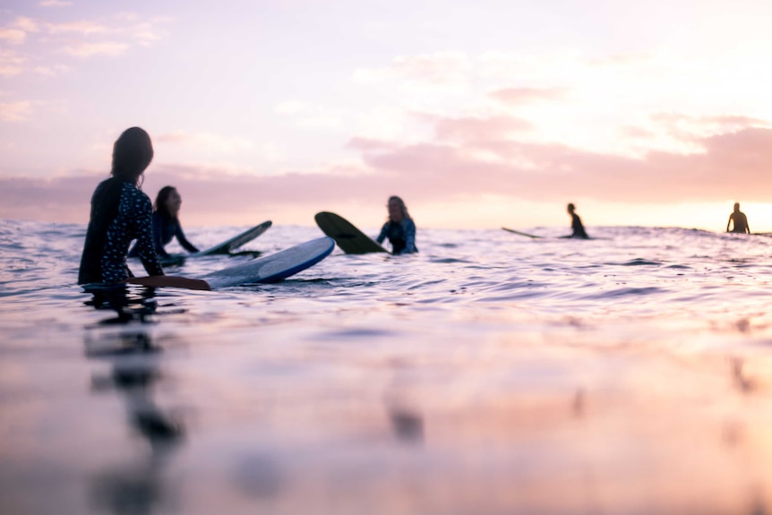 female surfers in the ocean