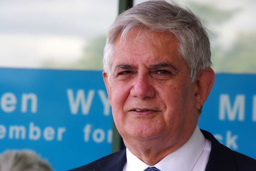 Federal Liberal MP and Member for Hasluck Ken Wyatt stares into distance wearing blue shirt.