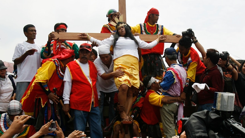 Precy Valencia, a penitent, is nailed to a wooden cross as part of the voluntary ritual