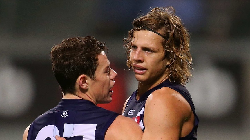 Milestone man ... Nat Fyfe (R) is congratulated by Lachie Neale during his 100th senior appearance