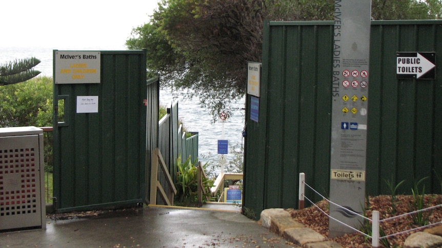 A gate way with signs saying "McIver's Baths". 