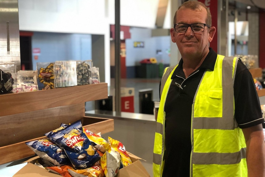 Man with chips in hi vis.