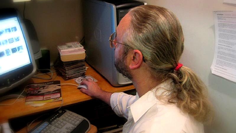 A man works at a computer.