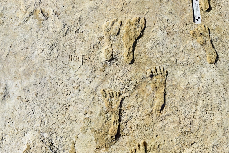 An image of human footprints in stone.