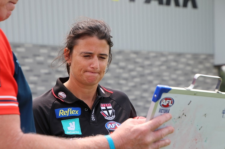 Peta Searle looks at a clipboard being held by Gary Ayre.