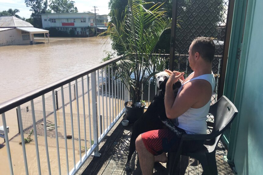 Rockhampton resident Stewart Stringer sits on his verandah of his flooded house