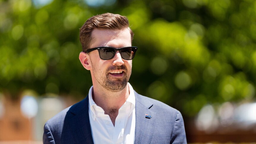 A man in a suit wearing sunglasses