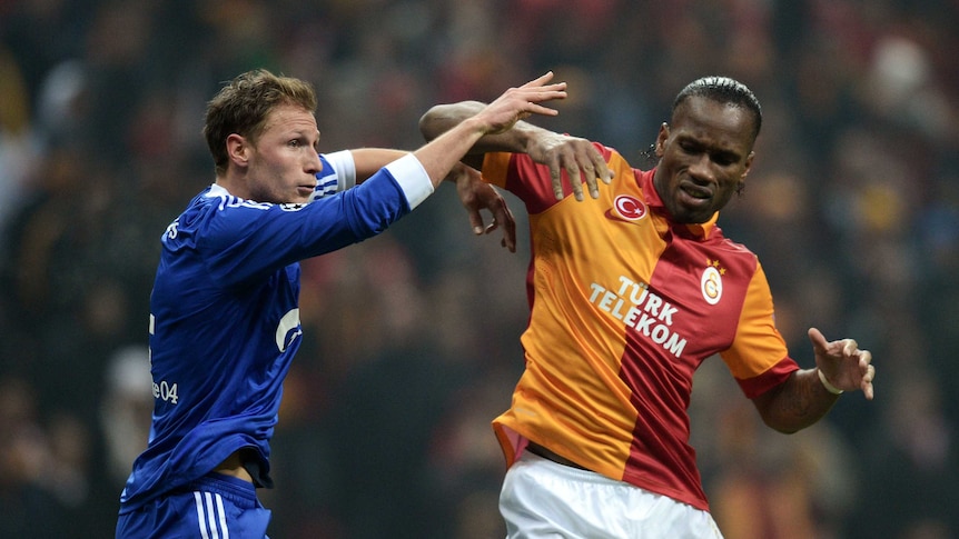 Didier Drogba jostles against Schalke 04