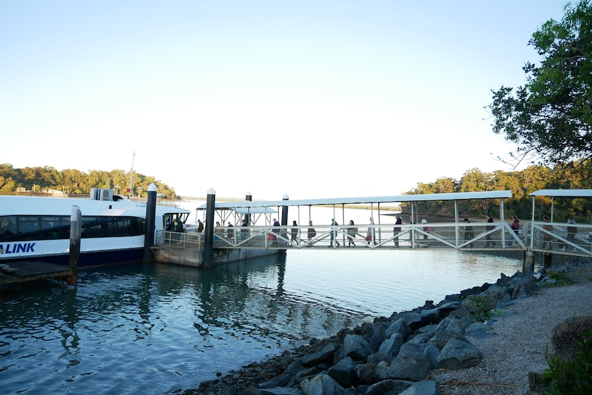 Peope boarding a ferry. 