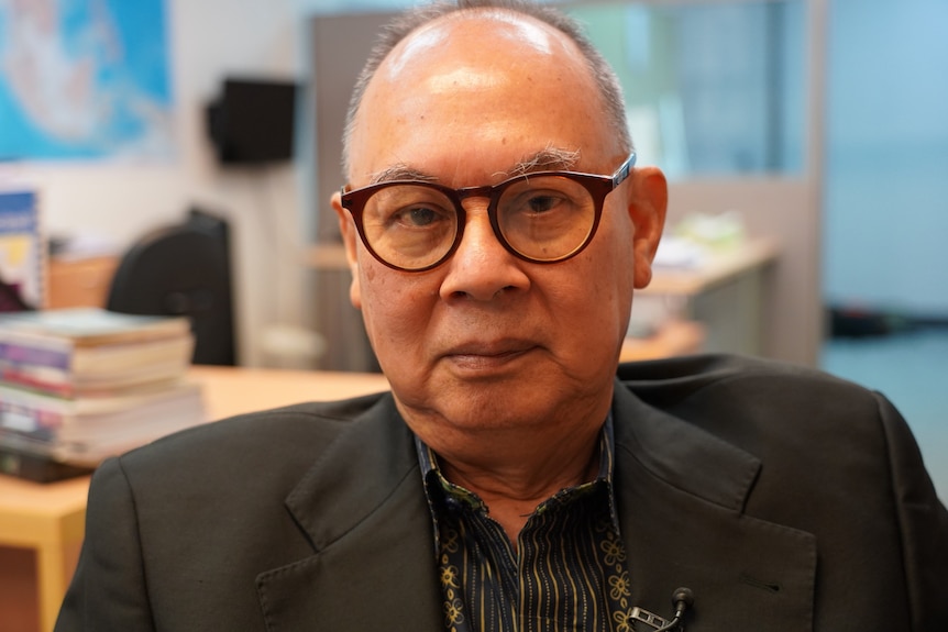 A Thai man in horn-rimmed glasses