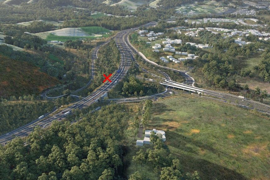 A long-shot view of a highway winding through bushland and around a town.