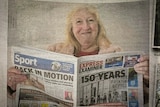 Woman reading newspaper pictured in newspaper