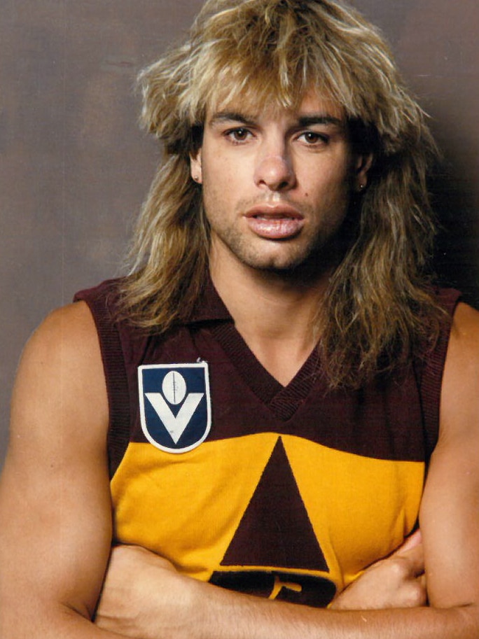 Man with blonde hair with arms crossed in an VFL Brisbane Bears uniform.