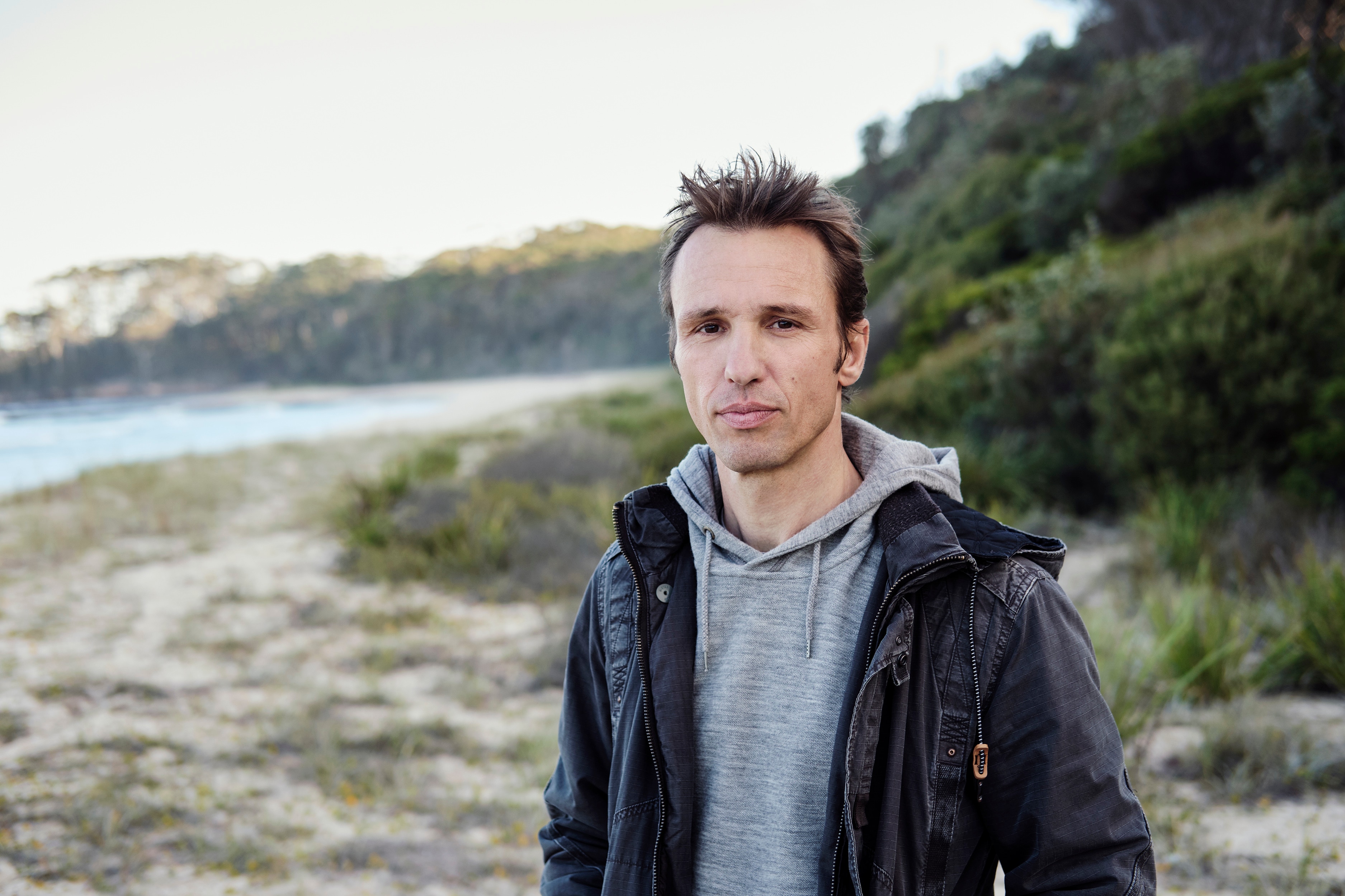 A man stands on a beach.