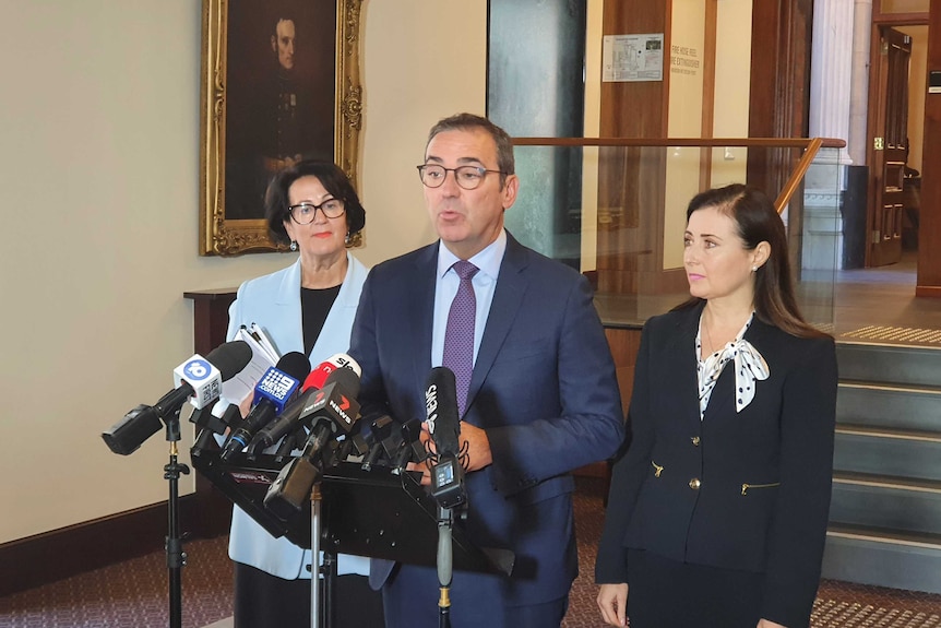 SA's Premier is flanked by the Attorney General and Child Protection Minister at a press conference.