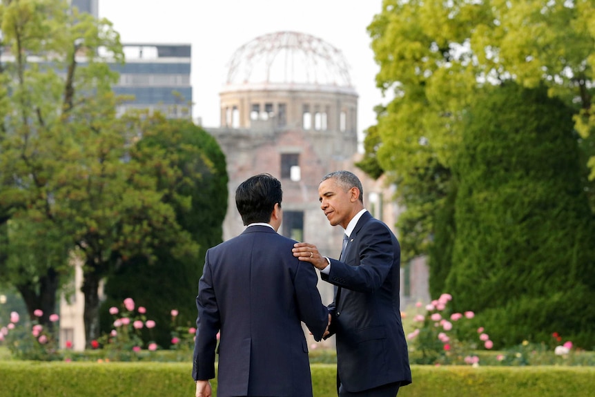 President Barack Obama puts his arm around Japanese Prime Minister Shinzo Abe
